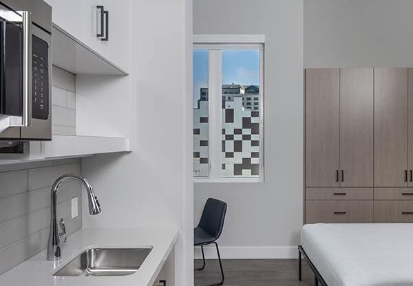 a kitchen with a sink a microwave and a window