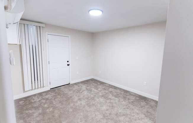 an empty room with white walls and a white door