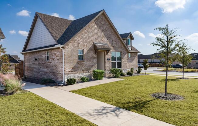 A thoughtfully designed single-family home at Amavi Celina with a private entry, landscaped yard, and a welcoming layout suited for everyday living.