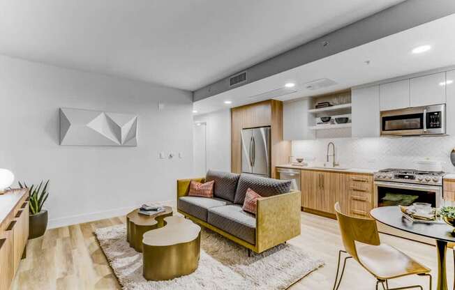 A modern living room with a yellow sofa and a white rug.