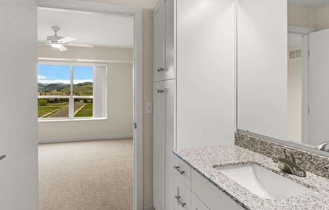 A bathroom with a window overlooking a street.