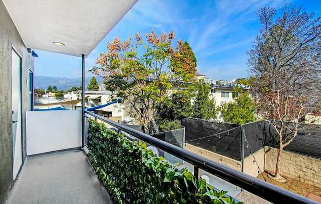 A balcony with a view of a residential area.