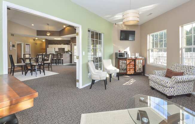 a living room and dining room with a table and chairs