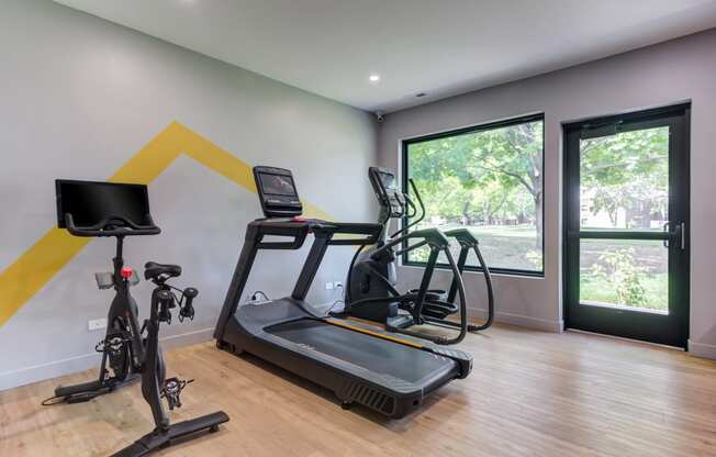 Gym with exercise equipment and a large window