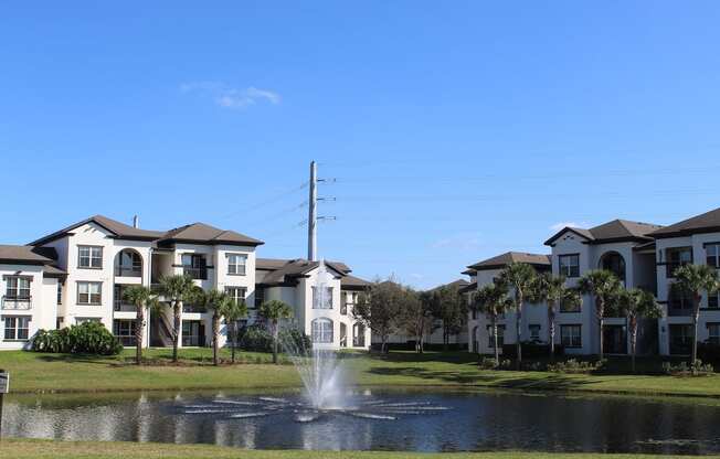 Fountain in pond beside apartment homes at Lake Nona Water Mark