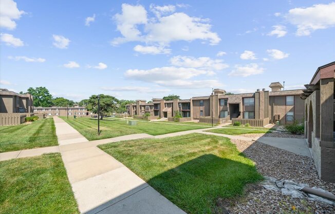 A sunny day at a residential area with houses and green lawns.