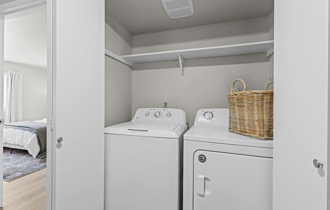a washer and dryer in a white laundry room