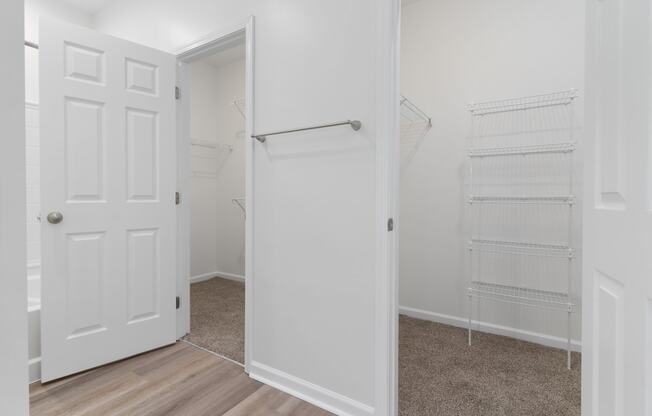 an empty bedroom with a closet and a white door