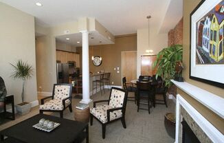 a living room with a table and chairs and a fireplace