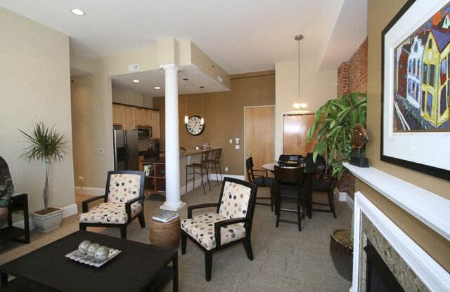 a living room with a table and chairs and a fireplace