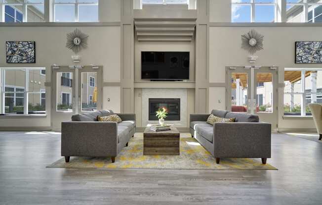 a living room with couches and a table and a fireplace