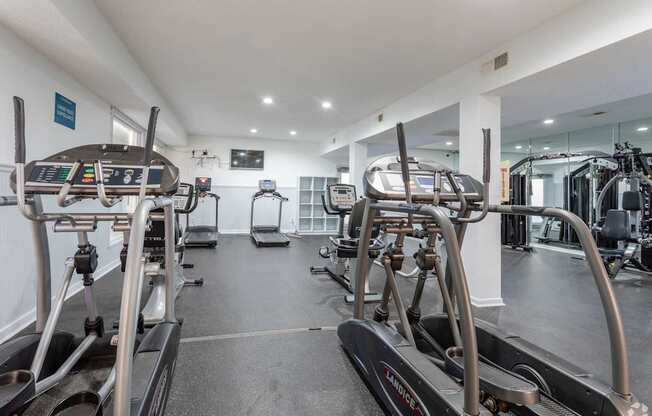 A gym with treadmills and elliptical machines.