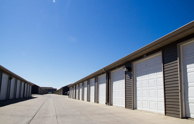 a row of garages on the side of a road