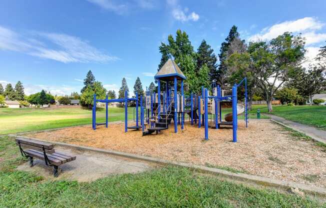 Nearby neighborhood park with play structure and mature trees and landscaping. 