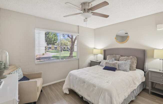 a bedroom with a large bed and a ceiling fan