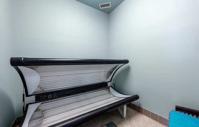a bench in the corner of a room with a blue wall