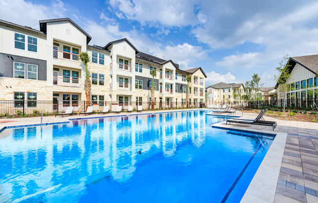 a large swimming pool in front of an apartment building at Legacy at Cibolo, Boerne, TX, 78006