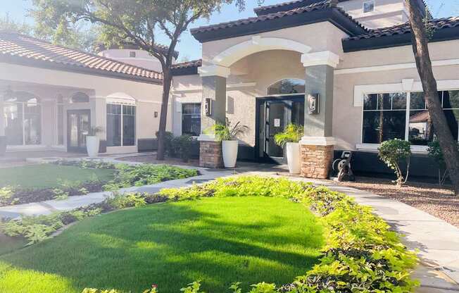 A house with a well-manicured lawn and a clear sky.
