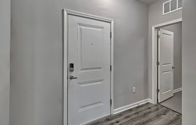 an empty bedroom with white doors and a door to a closet at Nexus at Sandhill, Columbia South Carolina