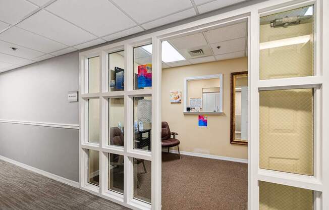 A room with a white door and a brown carpet at Hampton Apartments, Clearwater, Florida