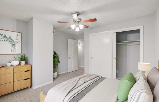 a bedroom with a bed and a ceiling fan