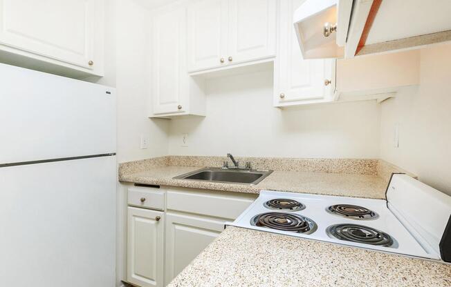 a white stove top oven sitting inside of a kitchen