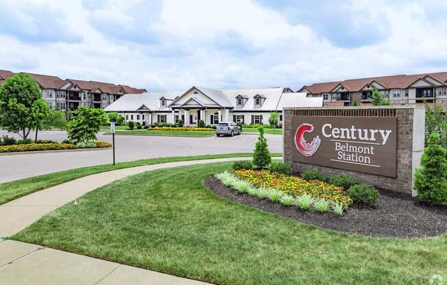 A sign for Century Belmont Station in front of a building.