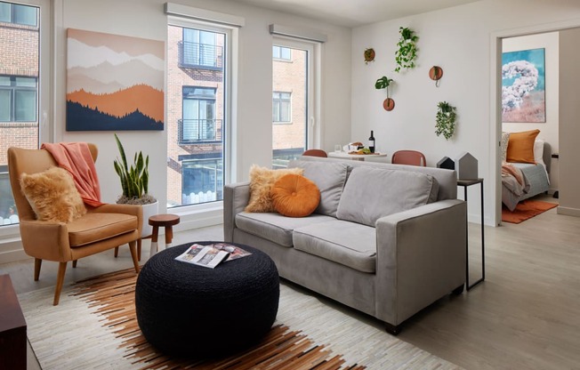 a living room with a couch and chairs and a rug