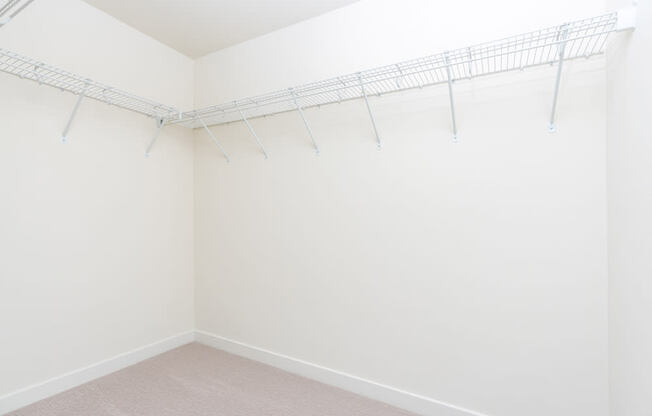 A white wall with a metal rack on it.