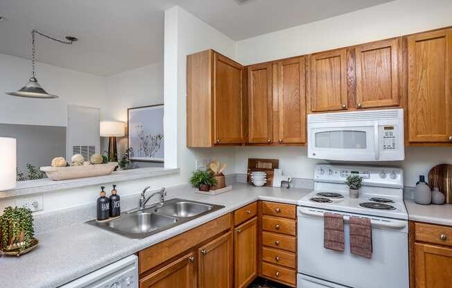 a kitchen with white appliances and wooden cabinets