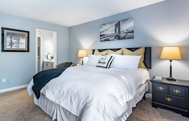 a bedroom with a large white bed and blue walls