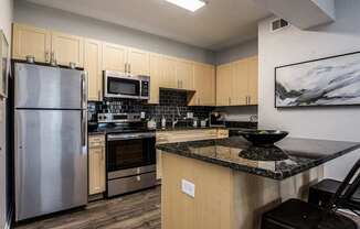 a kitchen with stainless steel appliances and granite counter tops