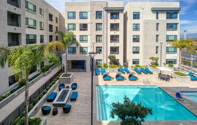 Resort‑inspired courtyard pool with shaded seating and greenery offering a bright outdoor hangout.