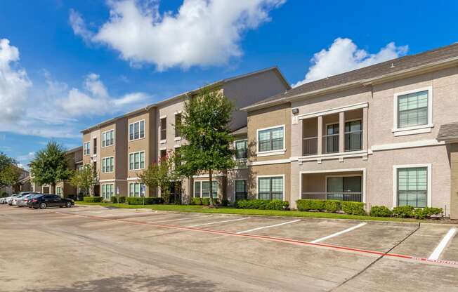 an empty parking lot in front of an apartment building at Summerwind, Pearland, TX