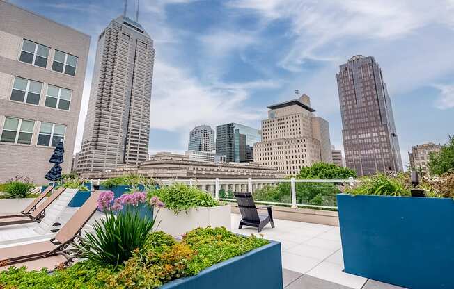 a roof terrace with a view of the city