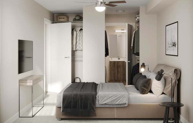 A bedroom with a bed, a TV, and a ceiling fan.