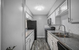 a kitchen with a sink and a mirror