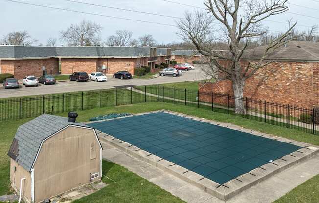 A small swimming pool surrounded by a black fence.