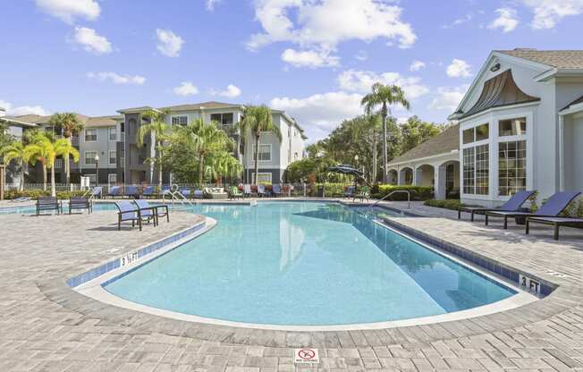 a large swimming pool with a building in the background