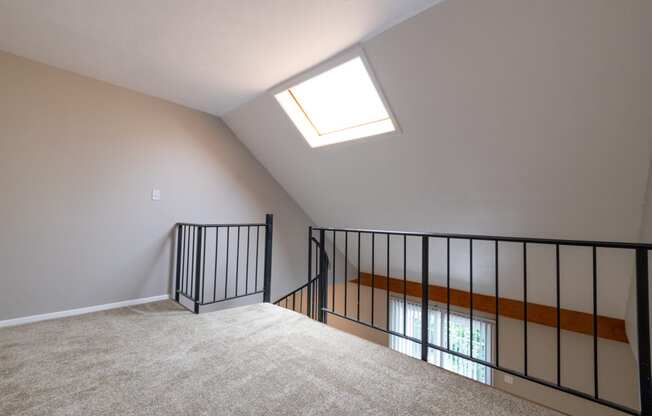 An Open Loft Space in the One Bedroom with Loft Apartment at Woodbridge Apartments Bloomington