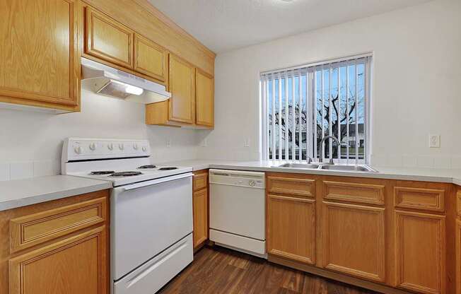 A kitchen with wooden cabinets and white appliances.