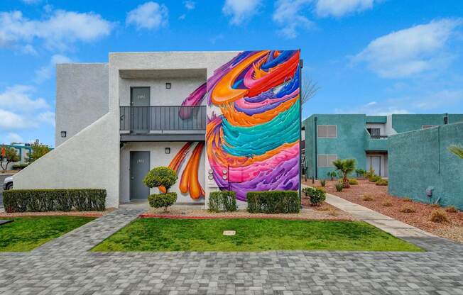 A colorful mural on a building in a residential area.
