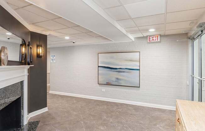 A room with a fireplace and a painting on the wall.