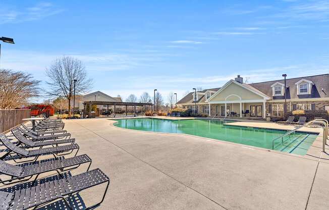 A large outdoor swimming pool surrounded by lounge chairs.