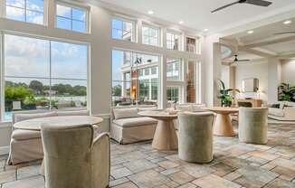 A spacious living room with a large window overlooking a tree-filled landscape.