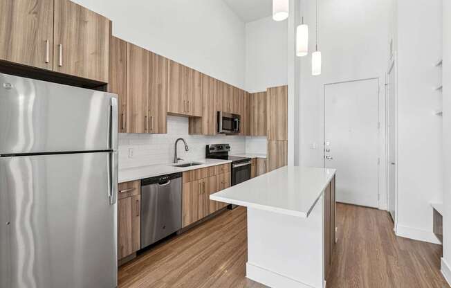 A modern kitchen with wooden cabinets and a white island.