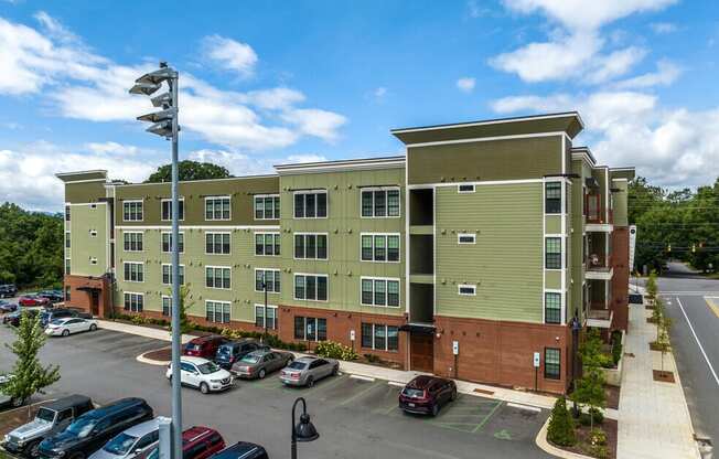 an aerial view of an apartment building with a parking lot