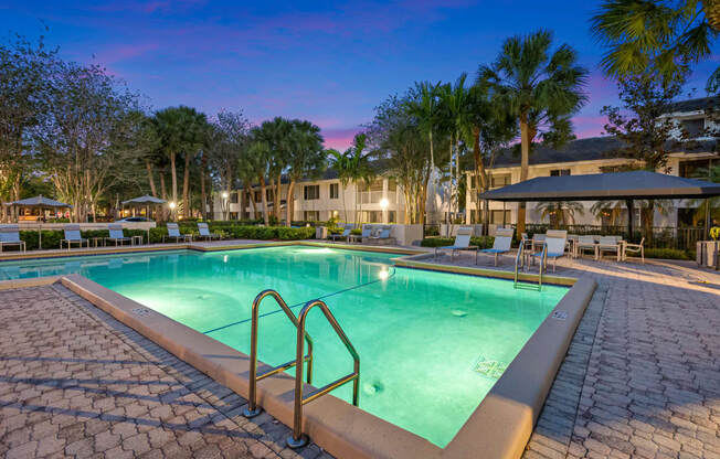 a resort style swimming pool at night at the resort at longboat key club