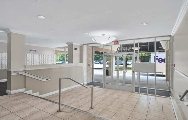 the entrance to the fedex office in a building with glass doors