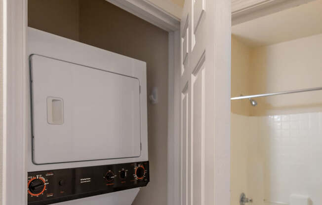 A white oven and dishwasher are built into a cabinet in a kitchen.